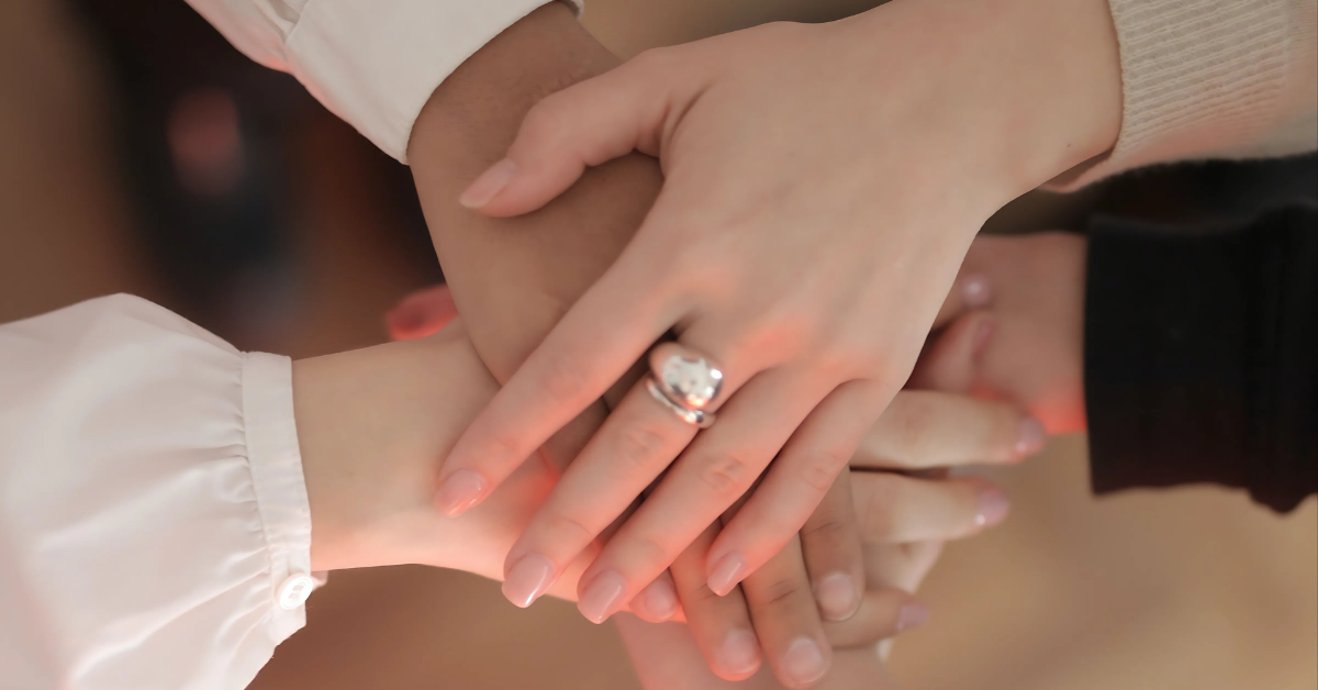 5 person having their hands on each other